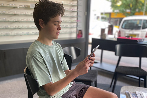 Young boy using screen at optometrists